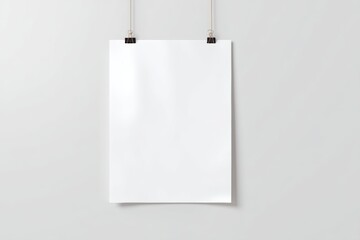 Mockup of a print-ready poster hanging on wall clips in vertical orientation against a white background