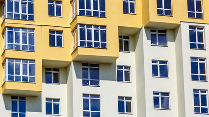 Extensive scaffolding providing platforms for work in progress on a new apartment block,Tall building under construction with scaffolds,Construction Site of New Building