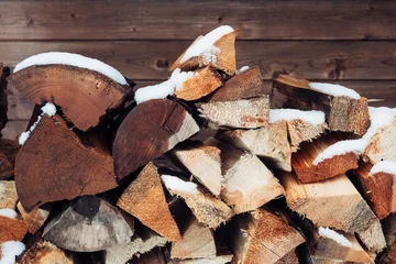 Fototapete Rund Brennholz A pile of wood with snow on top  © jr-art