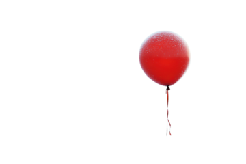 A frosty red balloon stands alone in a snowy field soft light winter scene peaceful solitude