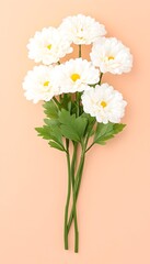 Obraz premium A bouquet of five creamy white artificial flowers with green stems, arranged on a peach background