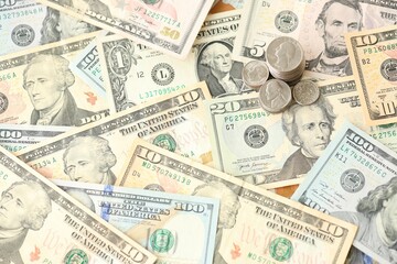 American US dollars money bills with coins and constitution close up on american flag