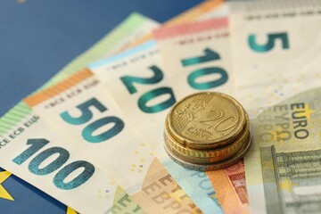 European union money currency Euro different paper notes and coins on flag