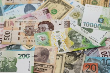 Big amount of money bills of different currencies and countries. Assortment background of international cash in big pile close up