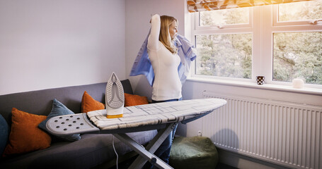 Iron, board and woman with shirt in morning, press cleaning or dressing for work as a cleaner in...
