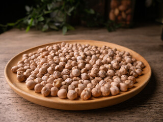 Raw Chickpeas on a rustic wooden table. Dry chickpea background close up. Chickpea legumes seed background.