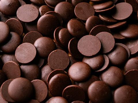 Dark Chocolate COUVERTURE chips Pistols buttons. Confection and pastry concept.