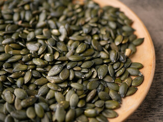Peeled dry pepita pumpkin seeds background.