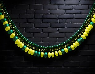 Obraz premium Green and Yellow Mardi Gras Beads on Black Brick Wall