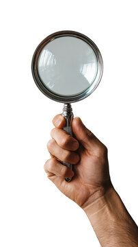 Hand holding a vintage magnifying glass with a silver frame against a black background.