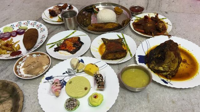 Full course Bengali thali for rice ceremony which includes rice, fishes, chicken, mutton, Sandesh and misti doi.