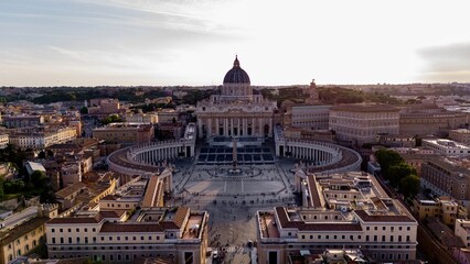 Aerial view of St. Peter's Basilica and St. Peter's Square in Vatican City at sunset, capturing the...
