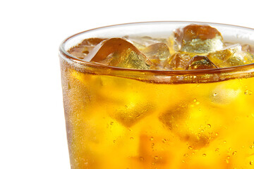 Transparent glass filled with ice-cold iced tea on a simple white background.