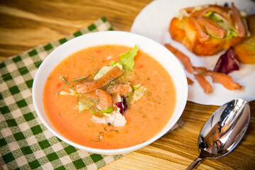 Healthy and delicate cream soup of red fish with dill