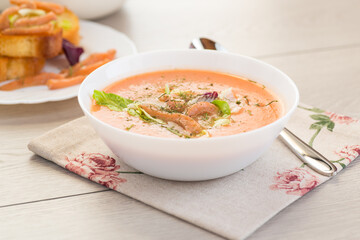 Thick and creamy cream soup of trout in a plate