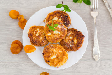 Homemade cheese pancakes with a delicate texture and aromatic dried apricots