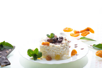 sweet cottage cheese breakfast in a plate with chocolate syrup with candied fruits