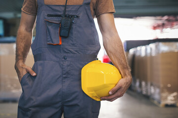 Young man checking stuff in storage room in factory