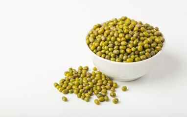 White bowl full of mung beans or dal on white background isolated