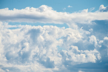 A cluster of cumulus thunderclouds in a bright blue sky during the daytime. Weather forecast. Thunderstorm formation. meteorology