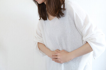 お腹を押さえる女性