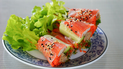 Fresh vegetable salad roll with crab stick eating with spicy salad dressing