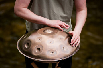 handpan outdoors near a waterfall