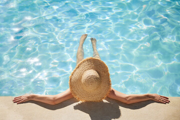 Top view of woman relaxing at swimming pool