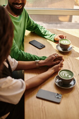 Happy moments shared by a couple over warm drinks in a cozy cafe setting