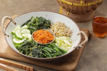 Urap is a lettuce dish in the form of cooked vegetables mixed with seasoned grated coconut for flavor