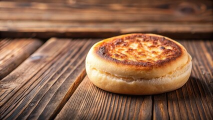 Toasted English muffin with crispy edges on a wooden table, breakfast, food