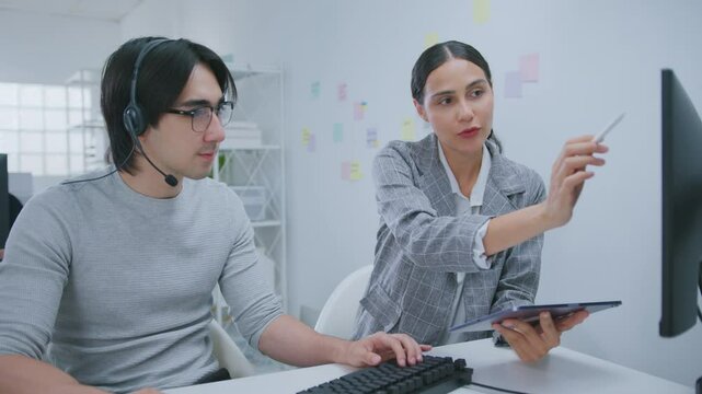 Learning, computer and training business interns in modern office. Customer service job, Cheerful asian business woman discussing project results with colleagues working together, software developers