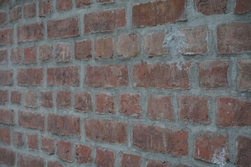 Abandoned red brick layered wall surface, Grungy brown brick wall texture background, Old and dirty rustic colored wall backdrop
