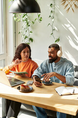 Couple enjoys productive remote work together in a cozy cafe setting