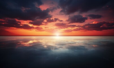 Obraz premium A vibrant sunset over a calm ocean, with dramatic clouds reflecting on the tranquil water.