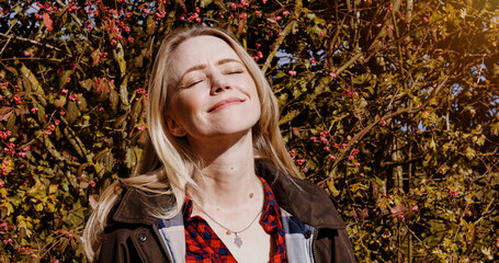 Fall, nature and portrait of woman with peace, freedom and happiness outdoor in garden or backyard. Autumn, trees and leaves in forest or person relax in park and breathing fresh air with sunshine
