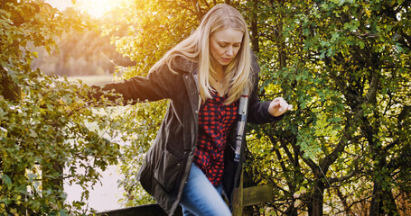 Countryside, morning and woman by fence walking for wellness, fresh air and relax outdoors. Trees, spring and person in field, meadow and farm for calm, peace and freedom in natural environment