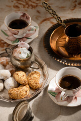 Turkish coffee with traditional sweets on antique carpet
