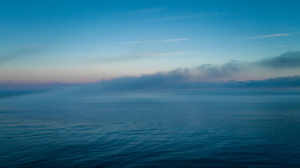 Fototapeta premium Serene ocean sunrise mist a breathtaking view nature's gentle beauty unveiled