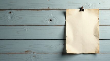 Fototapeta premium Rustic Wooden Background Featuring a Blank Aged Paper Sheet Attached with a Vintage Clip