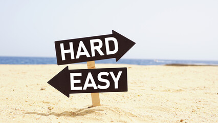 Direction indicator - choice of hard or easy way on two direction signs