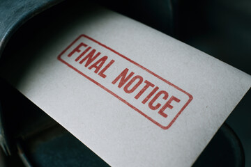 Final notice letter in mailbox warns about eviction and debt issues creating tense and urgent situation for recipient
