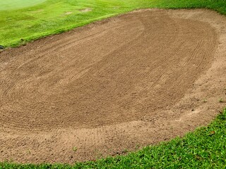 Golf Course Sand Pit Bunkers, green grass surrounding the beautiful sand holes is one of the most challenging obstacles for golfers and adds to the beauty of the golf course.