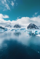 a serene landscape of antarctic mountains and icebergs reflected in the calm, deep blue waters under a cloudy sky.