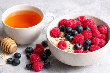 Hypertension wellness self care. Healthy Breakfast Bowl with Oats, Fresh Berries, and Herbal Tea for a Nutritious Start to Your Day