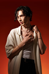 Stylish young man showcases trendy summer fashion in vibrant studio setting