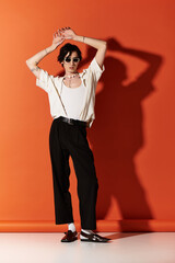 Stylish young man showcasing trendy summer fashion in a vibrant studio setting