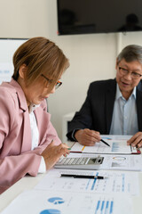 Senior businessmen calculating investment.
