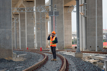 Engineer Inspecting Railway Track During Construction