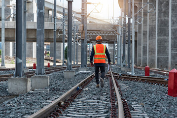 Engineer Inspecting Railway Track During Construction